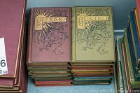 Stack of hardcover poetry books including Byron and Goethe with decorated gilded covers.