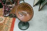 Front angled view of vintage Majestic No 7 heater showing copper-colored circular heating element guard and base.