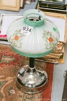 Full front view of Coleman gas lamp showing glass shade, base and overall condition