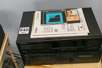 Photo showing Pioneer PD-4500 CD player with manuals and two CDs placed on top, clear view of front panel including tray and controls.