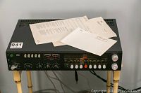 Overall view of pre-amplifier on stand with paperwork on top