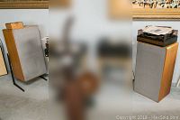 Pair of Braun LV1020 speakers in wood veneer with gray cloth grills and a turntable on the right speaker