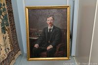 Full view of framed oil on canvas portrait showing man seated in chair with vintage attire and gold decorative frame.