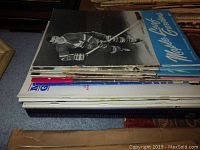 Stack of mixed vintage programs with black-and-white and color covers