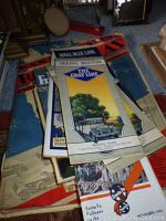 Photo showing a stack of vintage travel brochures including The Gray Line Boston brochure featuring a car and tree illustration, and other assorted travel brochures.