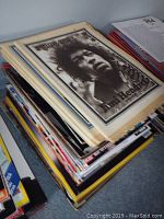 Stack of vintage music magazines with Jimi Hendrix Rolling Stone cover on top, showing age wear and patina.