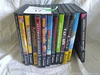 Photo shows 13 Nintendo GameCube games stacked side-by-side, displaying spines with titles and artwork.