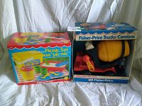 Photo showing two unopened Fisher-Price vintage boxed sets - a Picnic Set in a colorful box and a Cement Mixer Truck in an open face box.