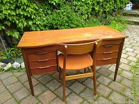 Front view of teak desk with matching chair