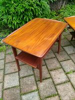 Two teak side tables outdoors on brick patio, showing overall appearance