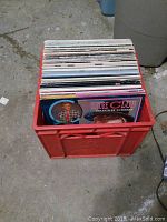 Top-down view of a plastic crate filled with vinyl record albums, showing numerous albums including Culture Club "Colour by Numbers".