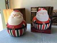 Photo of the Santa Claus cookie jar alongside its original box showing the jar's design and details.