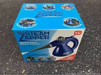 Box front showing Mini Steam Zapper steam cleaner image and uses: cleaning, sanitizing, deodorizing.