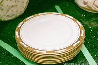 Stack of 7 Aynsley fine bone china plates showing gold and white Empress pattern border