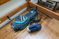 TaylorMade golf bag lying on wooden floor with accessory pouch