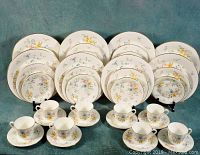 Full set arranged showing all plates and cups with saucers