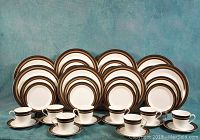 Full set arrangement showing 8 of each plate type and 8 cups with saucers