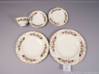 Top-down photo showing the cup, saucer, luncheon plate, bread and butter plate, and dinner plate arranged separately.