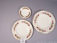 Three pieces of Royal Crown Derby Chatsworth pattern including saucer, salad plate, and luncheon plate, showing layout and decoration.