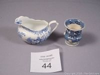Photograph showing both the Wedgwood creamer jug and the Royal Albert urn-shaped vase side by side from a top-front angle.