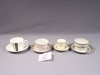 Four different cups and saucers arranged in a row showing each design