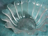 Close-up photo of the Wedgwood crystal bowl showing the scalloped petal edges and textured Daisy pattern base.
