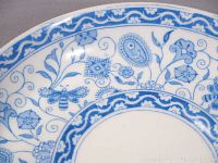 Close-up of the Blue Wilmot pattern featuring blue flowers and butterflies on white porcelain.