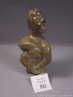 Overall view of the soapstone lady figurine highlighting shape and size.