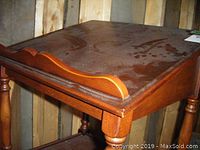 Close-up of top slanted surface with raised edge, showing minor surface marks