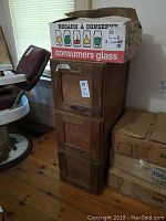 Front view of three‐drawer cabinet with cardboard box on top