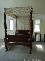 Full view of assembled bed frame with canopy fabric draped