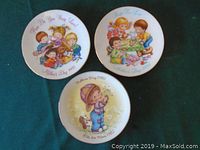 Three Avon Mother's Day 1982 collectible plates with child-themed pastel illustrations shown from front side.