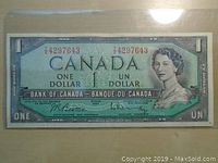 Front side of 1954 Canadian one dollar banknote showing Queen Elizabeth II portrait and serial number.