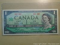 Front view of a 1967 Canadian one dollar bank note showing Queen Elizabeth II, issuance details, and signatures.