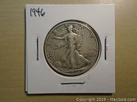 Obverse side of the 1946 US Walking Liberty Half Dollar showing Liberty walking toward the rising sun, with the date 1946 at the bottom, in a protective cardboard holder.