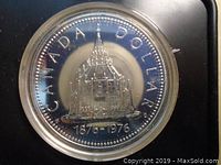 Front face of the coin showing the Library of Parliament dome with inscriptions.