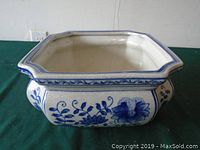 Side view of the square ceramic planter with blue floral pattern and octagonal top edge