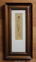 Framed pencil drawing of Victorian woman in antique wooden frame.