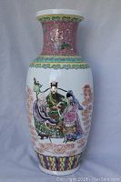Front view of the large decorative Chinese porcelain vase showing figures and decorative bands.