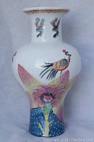 Full view of front side showing the bird perched on a flower and part of the floral design.