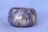 Side view showing purple and yellow lustre glaze with textured pattern