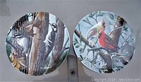 Front view showing both plates side by side with distinct bird illustrations