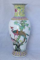 Front view showing body design of birds and tree on vase.
