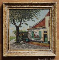 Front view of hand-painted Dutch ceramic tile in textured wooden frame showing detailed countryside scene