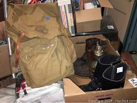 Overview of lot showing Boy Scouts backpack, boots in box and glass decanter