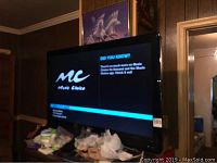 Front view of the Philips television powered on showing Music Choice app screen