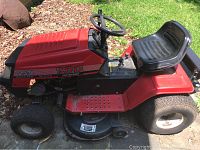 Side profile photo of red MTD Yard Machines riding mower showing the seat, steering wheel, and 12.5/38 branding.