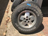 Photo of Firestone Wilderness AT tire mounted on a rim showing brand name and tread pattern.