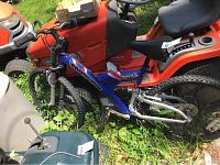 Full side view of blue Mongoose DH2.5 mountain bike showing frame, tires, seat, and handlebar