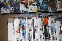 Photo showing multiple video game cases mainly PlayStation 3 and PlayStation 4 games lined up in a box.